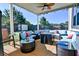 Relaxing backyard patio with comfortable seating, ceiling fan, and a view of the spacious fenced yard at 165 Craines Vw, Covington, GA 30014