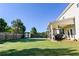 Large backyard with a patio, storage shed, and plenty of green space for outdoor activities at 165 Craines Vw, Covington, GA 30014