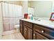 Bathroom with dark wood vanity, a large mirror and tile floors at 165 Craines Vw, Covington, GA 30014