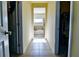 Hallway leading to a bright bathroom with a soaking tub and a closet with shelving at 165 Craines Vw, Covington, GA 30014