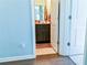 Cozy half bathroom with a dark wood cabinet and neutral decor seen through the doorway at 165 Craines Vw, Covington, GA 30014