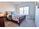 Bright bedroom features a comfortable bed and a large window, creating a cozy and inviting atmosphere at 165 Craines Vw, Covington, GA 30014