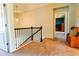 Bright hallway with staircase and view into bedroom with rich blue walls and furnishings at 165 Craines Vw, Covington, GA 30014