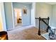Upstairs hallway with carpet, railing, and blue walls at 165 Craines Vw, Covington, GA 30014
