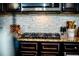 Kitchen cooktop with granite countertops, stainless steel appliances, and a tile backsplash at 165 Craines Vw, Covington, GA 30014