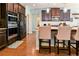 Modern kitchen features dark cabinets, stainless steel appliances, and a breakfast bar with seating at 165 Craines Vw, Covington, GA 30014
