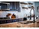Beautiful kitchen features granite countertops, stainless steel appliances, and a modern faucet at 165 Craines Vw, Covington, GA 30014