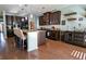 Spacious kitchen with dark wood cabinets, granite countertops, and a large island with barstool seating at 165 Craines Vw, Covington, GA 30014