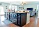 Modern kitchen island with dark cabinetry, granite countertops, and seating at 165 Craines Vw, Covington, GA 30014