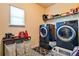 Well-appointed laundry room featuring modern washer and dryer units, ample storage, and stylish flooring at 165 Craines Vw, Covington, GA 30014