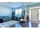 Cozy living room with comfortable seating, shelving, and a bright front door at 165 Craines Vw, Covington, GA 30014