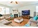 Inviting living room featuring a fireplace, plush seating, and a large television for cozy gatherings at 165 Craines Vw, Covington, GA 30014