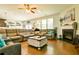 Comfortable living room featuring a fireplace, large sectional, and lots of natural light at 165 Craines Vw, Covington, GA 30014