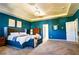 Large main bedroom with blue walls, walk in closet, sitting area, and stylish furnishings at 165 Craines Vw, Covington, GA 30014