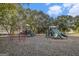 Community playground featuring green and gray slides and metal jungle gyms, surrounded by trees at 165 Craines Vw, Covington, GA 30014