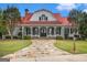 Traditional home with a stone walkway and a wide covered porch, nestled on a sprawling green lawn at 165 Craines Vw, Covington, GA 30014