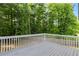 Painted gray wooden back deck has white railings and overlooks a private wooded lot at 4170 Maroney Mill Rd, Douglasville, GA 30134