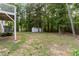 Large backyard with mature trees, storage shed, and space for outdoor activities at 4170 Maroney Mill Rd, Douglasville, GA 30134