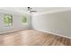 Spacious bedroom with hardwood floors, ceiling fan, and large windows offering natural light and scenic views at 4170 Maroney Mill Rd, Douglasville, GA 30134