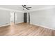 Bedroom with hardwood floors, ceiling fan, and view into an ensuite bathroom and walk in closet at 4170 Maroney Mill Rd, Douglasville, GA 30134