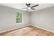 Bright bedroom features hardwood floors, a ceiling fan, and large windows offering natural light at 4170 Maroney Mill Rd, Douglasville, GA 30134