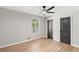 Neutral bedroom features hardwood floors, a ceiling fan and two toned doors, creating a serene atmosphere at 4170 Maroney Mill Rd, Douglasville, GA 30134