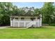 Charming home with a white lattice-covered porch and a well-maintained front yard surrounded by lush trees at 4170 Maroney Mill Rd, Douglasville, GA 30134