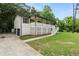 Inviting exterior featuring a white lattice-covered porch, a driveway leading to the garage, and green landscaping at 4170 Maroney Mill Rd, Douglasville, GA 30134