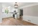 Well-lit kitchen featuring white cabinets, stainless steel appliances, and wood-look flooring at 4170 Maroney Mill Rd, Douglasville, GA 30134
