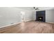 Spacious living room with wood-look flooring, a black accent fireplace, and neutral gray walls at 4170 Maroney Mill Rd, Douglasville, GA 30134