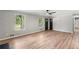 Bright living room featuring wood-look flooring, large windows, and a view of the outdoor greenery at 4170 Maroney Mill Rd, Douglasville, GA 30134