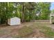 Outdoor storage shed nestled among mature trees and a spacious yard at 4170 Maroney Mill Rd, Douglasville, GA 30134