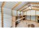 Interior view of the storage shed with shelving and workbench at 4170 Maroney Mill Rd, Douglasville, GA 30134
