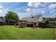 Well-maintained backyard with green lawn, mature trees, and a pergola-covered patio for relaxing at 7095 Valley Landing Ct, Cumming, GA 30041