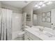 Neutrally decorated full bathroom with tub/shower combo with patterned shower curtain and single sink at 7095 Valley Landing Ct, Cumming, GA 30041