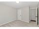 Bedroom with neutral walls and carpet with one window and two doors at 7095 Valley Landing Ct, Cumming, GA 30041