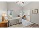 Bedroom with vintage desk, lamps, and ensuite bathroom, neutral decor at 7095 Valley Landing Ct, Cumming, GA 30041