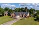 Beautiful aerial shot of the brick home and expansive green lawn on a bright, sunny day at 7095 Valley Landing Ct, Cumming, GA 30041