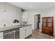 Open kitchen layout with stainless steel appliances, granite counters, and view to the laundry room at 7095 Valley Landing Ct, Cumming, GA 30041