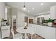Well-lit kitchen with a breakfast table, stainless steel appliances, and wood-look flooring at 7095 Valley Landing Ct, Cumming, GA 30041