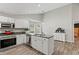 Charming kitchen featuring granite countertops, stainless appliances, and white cabinetry at 7095 Valley Landing Ct, Cumming, GA 30041