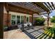 Covered patio with outdoor seating and a view of the landscaped backyard, with plenty of sunlight at 7095 Valley Landing Ct, Cumming, GA 30041