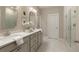 Bathroom featuring double sinks with stone countertops and a glass shower enclosure at 714 Chipping Sparrow St, Canton, GA 30115