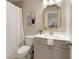 Well-lit bathroom with a vanity, a toilet, a shower with curtain, and elegant decor at 714 Chipping Sparrow St, Canton, GA 30115