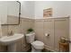 Cozy powder room features wainscotting, modern fixtures and a pedestal sink at 714 Chipping Sparrow St, Canton, GA 30115