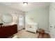 Neutral Bedroom with a textured wall and full-sized crib and dresser at 714 Chipping Sparrow St, Canton, GA 30115