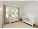 Bright Bedroom with a floral accent wall and a full-sized crib at 714 Chipping Sparrow St, Canton, GA 30115