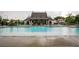 Large community pool with lounge chairs, tables and umbrellas at 714 Chipping Sparrow St, Canton, GA 30115