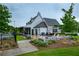 Clubhouse exterior with covered seating, fire pit, lush landscaping, and community amenities at 714 Chipping Sparrow St, Canton, GA 30115