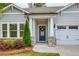 Close-up of front door with stone accents, address number and lovely wreath at 714 Chipping Sparrow St, Canton, GA 30115